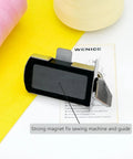 Front view of WENICE magnetic seam guide for sewing machines; black rectangular body with metal clips
