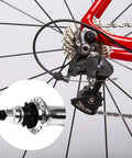 Close-up of a bike's rear derailleur and cassette with inset showing the Eight Piece Bike Headset Spacers Set For Road And Mountain Bikes Aluminum Alloy Washers With Seven Sizes 1.0 1.5 1.85 2.0 2.18 2.35 2.5 mm Easy Dial In For Cassette And Bottom Bracket Spacing.