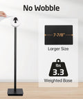Rock Solid Free Standing Toilet Paper Holder In Matte Black Stainless Steel With No Wobble Heavy Base And 26 Inch Tall Design, SUS304 18 8 Stainless Steel, showing weighted base and size details with a hand reaching to replace roll