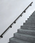 Rock Solid Wall Mounted Stair Handrail Premium Stainless Steel Safety Rail with Pre Drilled Mounting Holes on gray stairs.