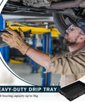 Mechanic using Oil Drain Pan Drip Tray 24 By 15.5 Inch Leak Proof Plastic Catch Pan for under vehicle maintenance