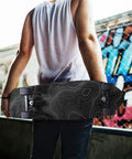 Person holding skateboard with Contour Map Grip Tape For Skateboards 33 By 9 Inches Black With White Contour Lines, urban background.