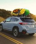 Car with kayaks secured by Beefy 16 Foot Tie Down Straps With Rubber Padded Cam Lock Buckle, 1 Inch Wide, 600 Lb Working Load on roof rack