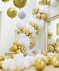 Top Tier 12 Inch Gold Latex Helium Balloons 50 Pack Slay Party Decorations in a stylish balloon arrangement.