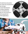 Front view of 38mm aluminum omni wheel with metal hub and black segmented rollers; paired with a white robotic dinosaur toy.