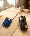 Hands On Soldering Practice Kit For Electronics Newbies Do It Yourself Learning Board with battery pack on wooden desk