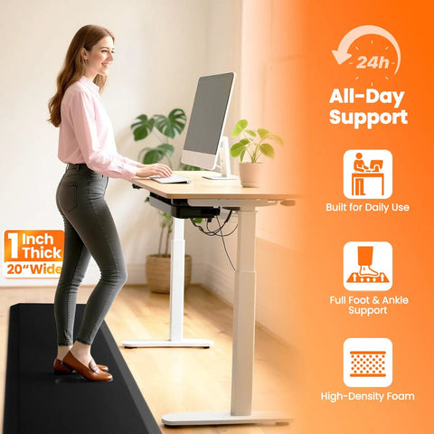 Woman standing on 1 Inch Thick Anti Fatigue Kitchen Mat For Floor Non Slip Waterproof Standing Desk Mat For Kitchen Use Ideal For Cooking Cleaning And Working At The Counter Or Sink Black 20 By 72 Inches at a desk.