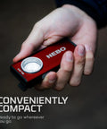 Hand holding Slim Pocket Flashlight With 500 Lumens Rechargeable Mini EDC Work Light Magnetic Base Dimmable Brightness Durable Water Resistant Includes Charging Cable Red