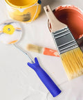 Double Ended Paint Roller Corner Tool With Comfy Grip Handle For Easy Wall Painting alongside paint brushes and cans.