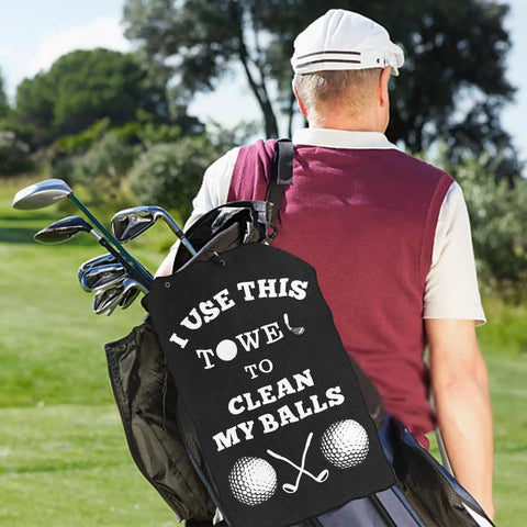 Golfer with bag, featuring Premium Golf Towel Gift For Men And Golf Dudes With Clip Microfiber Cleaning Cloth For Bags Balls And Clubs Funny Practical Stocking Stuffer For Christmas Birthday And Valentines Day.