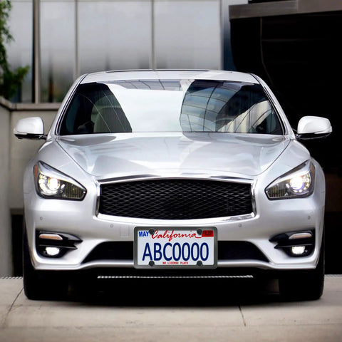 Silver car with a front license plate secured by Black Anti Theft License Plate Screws Kit With Stainless Steel 1/4 Inch Security Mounting Hardware Includes Caps Inserts Rattle Proof Pads For Car Tags And Frame Mounting Easy Bolt On Tamper Proof Design.