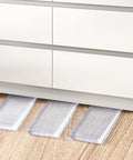 8 Pack Clear Furniture Leveler Shims Non Slip Rubber Table Wedges For Uneven Floors used under a dresser on hardwood floor.
