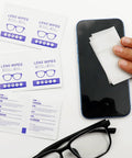 Using Alcohol Free Lens Wipes For Glasses And Screens Streak Free 220 Count on a smartphone next to glasses and packaging