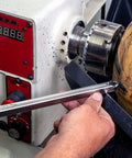 12-inch stainless steel 90° carbide turning tool for acrylic/resin, side view, Amazon brand, held near a wood lathe