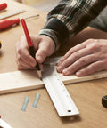 Person measuring wood with ruler and pencil next to screws from Eight Piece Hacksaw Bolt And Wing Nut Set For DIY Repairs Tough Pro Grade Hardware Kit