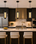 Alabaster Pendant Lights, Smoky Gray Glass Pendant Light Fixtures in modern kitchen over marble island with gold accents.