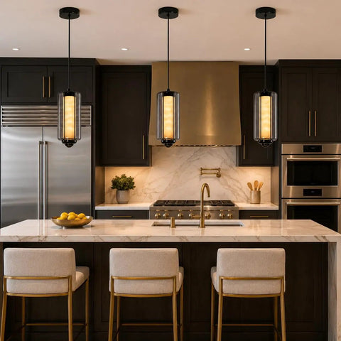 Alabaster Pendant Lights, Smoky Gray Glass Pendant Light Fixtures in modern kitchen over marble island with gold accents.