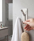 Insane Grip No Drill Towel Hooks Six Pack Silver Rust Proof Heavy Duty Bathroom Wall Mount shown holding a towel and bath scrubber.