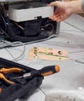 Drop Down Chest Freezer Hinge Replacement With Durable Metal Spring being installed under a freezer, tools visible on the floor.