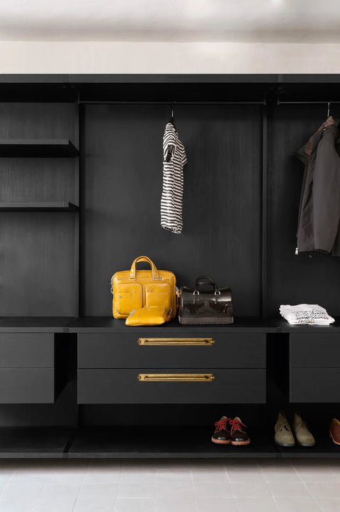 Closet with drawers featuring antique brass zinc alloy cabinet handle with backplate and bags for visual context.