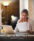 Tall Torchiere Floor Lamp With Adjustable Reading Light next to a woman reading at a desk, 71-Inch Tall Pole visible.