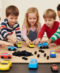 Children playing with toy cars and trucks, using Bulk Pack Of 300 Mini Plastic Model Wheels With 2mm Holes And 150 100mm Metal Axle Rods