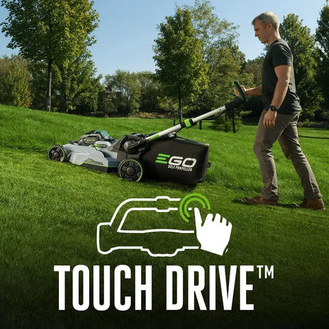 Man using Cordless Self Propelled Electric Lawn Mower With Select Cut Blades And Touch Drive on grass