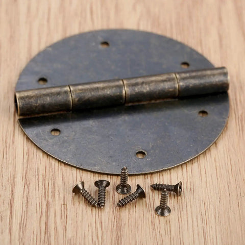 Close-up of 2 Pack 60mm Antique Bronze Round Door Butt Hinges for wood boxes and cabinets with screws on wooden surface