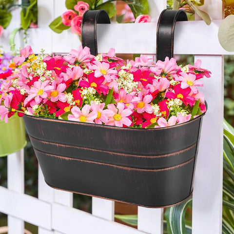 4 Pack Black Metal Hanging Flower Pots To Level Up Railing Decor Iron Planters With Drain Holes Rust Resistant Bucket Holders For Fence Balcony Yard Rock Solid Detachable Hooks filled with pink flowers on railing.