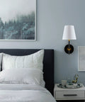 Bedroom with 1 Light Wall Sconce With Plug In Cord And White Fabric Shade In Matte Black Finish above nightstand.