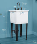 Space Saving Utility Sink With Gooseneck Faucet And Side Sprayer Narrow White Tub Black Faucet in corner of laundry area