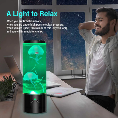 Jellyfish Lamp Liquid Table Lamp With Remote Control Color Changing Night Light For Aquarium Tanks Kid And Adult Friendly Decor Awesome Gift For Christmas And Birthdays placed on desk with green glow and man relaxing nearby.