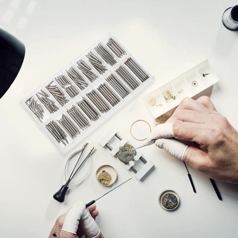Pro Grade Stainless Steel Watch Band Pins Replacement Kit with 270 Spring Link Rods used by watchmaker on desk