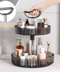 2-Tier Lazy Susan With 360 Degree Rotation Height Adjustable Turntable Organizer Rack For Spice Jars And Bottles, shown on bathroom countertop with handle, dark gray.