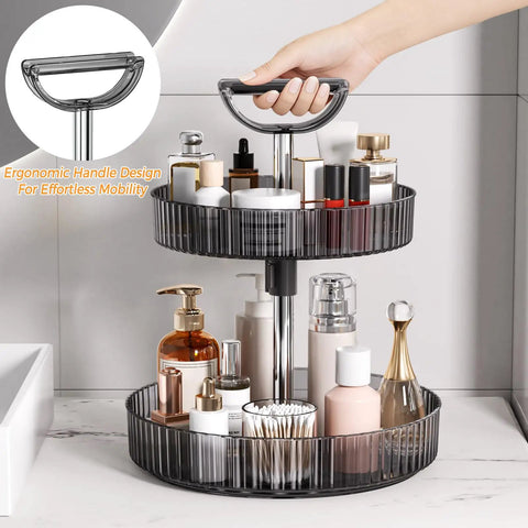 2-Tier Lazy Susan With 360 Degree Rotation Height Adjustable Turntable Organizer Rack For Spice Jars And Bottles, shown on bathroom countertop with handle, dark gray.