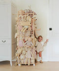 Vertical Plush Toy Organizer From Solid Pine Wood Space Saving Stuffed Animal Storage with toys and child nearby