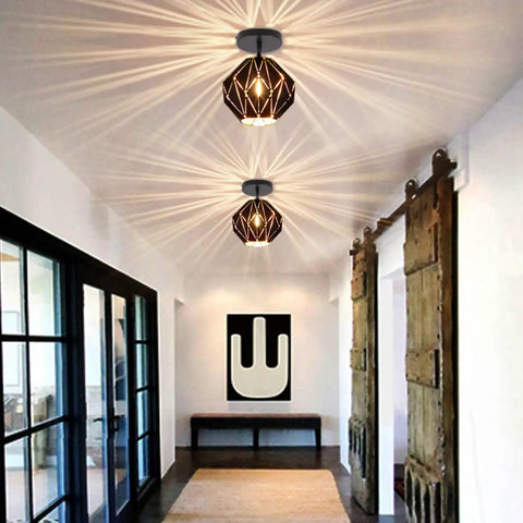 Industrial Vintage Pendant Light With Diamond Geometric Shade In Matte Black Metal illuminating a hallway with barn doors.