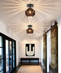 Industrial Vintage Pendant Light For Kitchen Island Dope Black Metal Ceiling Fixture With Creative Geometric Diamond Shade glowing in hallway.