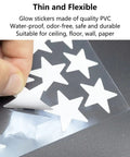 Close-up of Dope Glow In The Dark Star Stickers Set on PVC sheet with hand peeling a star for ceiling and wall decor
