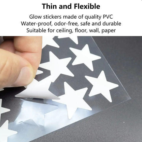 Close-up of Dope Glow In The Dark Star Stickers Set on PVC sheet with hand peeling a star for ceiling and wall decor