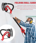 Man using Beast 750W Drywall Sander with Vacuum and LED Light on white wall, showing foldable disc and dust-collection feature.