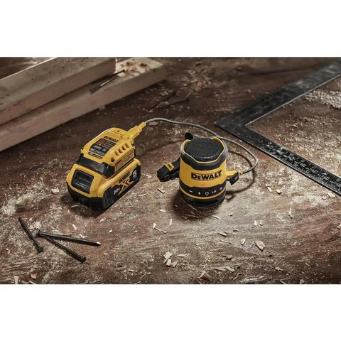 Rugged Jobsite Bluetooth Speaker With USB C Rechargeable Battery IP67 Dust And Water Resistant on a construction site table