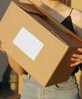 Person holding a box with 160 Sheets White Synthetic Paper Shipping Labels With Super Sticky Adhesion And Ample Writing Space