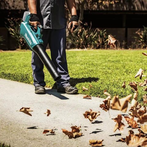 Man using 18V LXT Brushless Cordless Blower With Cruise Control, Variable Speed Trigger, And Speed Lock For Continuous Operation.