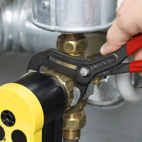 Cobra Pliers Set 7 10 And 12 Inch Three Piece With Non Slip Plastic Coated Handles in use on plumbing valve for quick adjustment.
