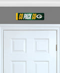 Premium Green Bay Packers Metal Street Sign Wall Art featuring bold graphics above a white door in a home interior.