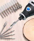 Wood Carving And Engraving Drill Bit Set 15 Piece Kit with engraving bits, HSS carbide rotary burrs, and rotary tool on wood surface.