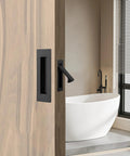 Side view of pocket door with matte black flush handles, showing modern design for sliding doors, includes two 6x2 inch pulls, 3.15x0.87 inch edge pull.