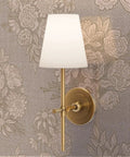 Top Shelf Vintage Peony Silver Metallic Wallpaper Featuring Smooth Fabric Texture And Eco Friendly Design For That Dreamy Room Glow Up And Easy Paste On Wall Install With Durable Build And Class A Rated For Sharp Home Vibes with a stylish wall sconce.