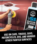 Bottle of One Step Scratch And Swirl Remover Compound And Polish next to person using polisher on car door